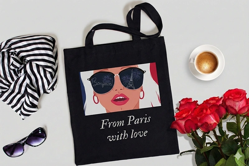 Must riidest kott erksa värvilise prindi ja tekstiga. Näide kvaliteetsest kangatrükist eritellimusel